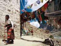 A Buddhist pilgrim walks past a Gompa in Tibet |  <i>Jamie Williams</i>